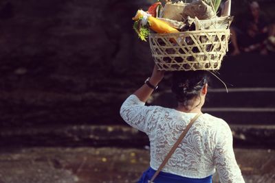 Rear view of man standing in basket