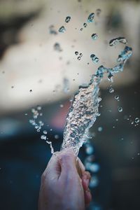 Close-up of hand splashing water