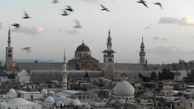 architecture, building exterior, built structure, bird, dome, sky, flying, place of worship, city, religion, spirituality, animal themes, cloud - sky, church, roof, animals in the wild, cityscape, mosque