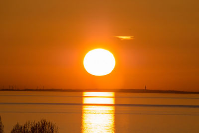 Scenic view of sea against orange sky
