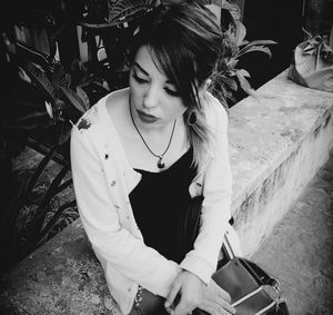 Portrait of a young woman sitting outdoors