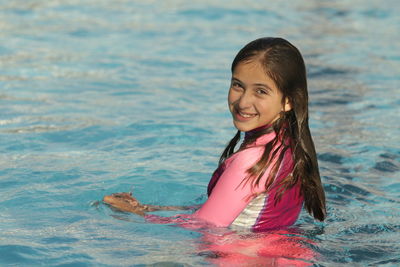 Portrait of happy girl in swimming pool
