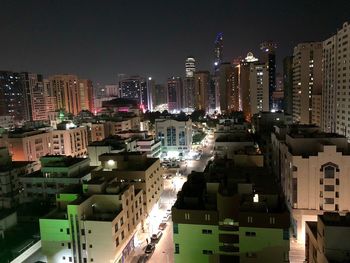 High angle view of illuminated buildings in city at night