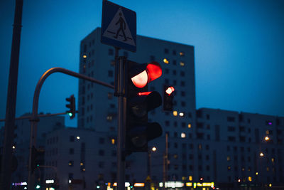 Road signal against buildings at night