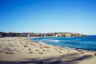 Scenic view of beach against clear blue sky