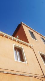 Low angle view of building against clear blue sky