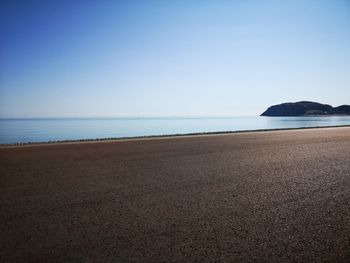 Scenic view of beach against clear sky