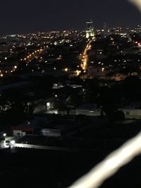 High angle view of illuminated buildings in city at night