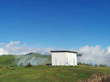 Built structure on field against sky