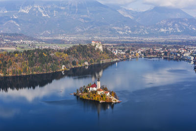 High angle view of lake by mountain against sky