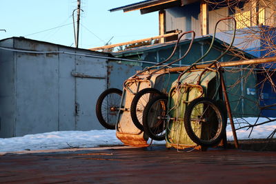 Bicycle parked on snow covered metal during winter