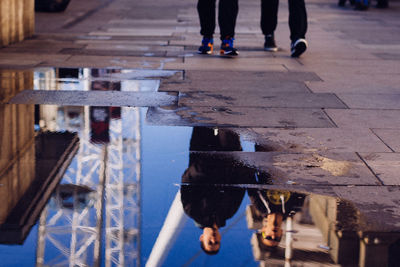 Low section of people standing in puddle