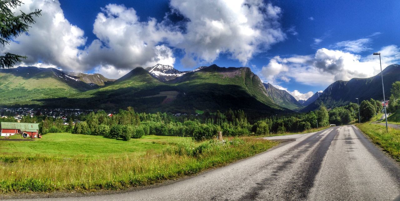 mountain, the way forward, road, sky, transportation, country road, mountain range, landscape, diminishing perspective, cloud - sky, grass, tranquil scene, road marking, tranquility, cloud, vanishing point, scenics, nature, empty road, beauty in nature