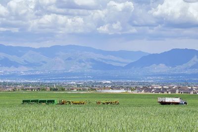 Vintage farm truck and harvest machinery with rocky mountains, great salt lake valley utah. usa.