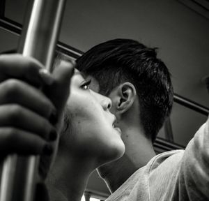 Close-up portrait of young man looking away at home