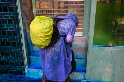 Woman standing on wet glass during rainy season