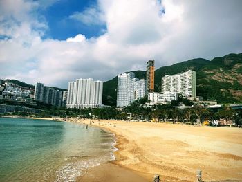 Panoramic view of beach and buildings against sky