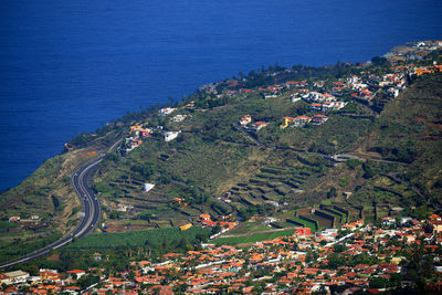 High angle shot of townscape against blue sea