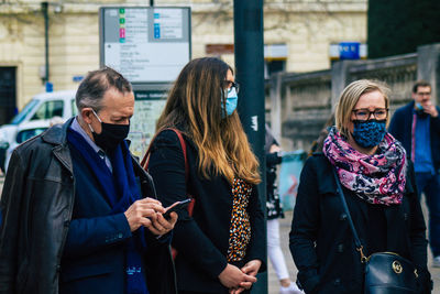 Women standing on mobile phone