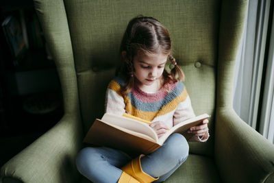 Girl sitting on book