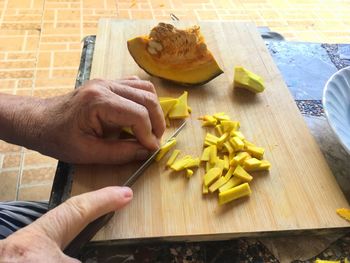 High angle view of person preparing food on cutting board