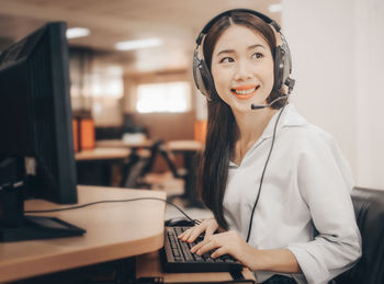 Portrait of a smiling young woman using mobile phone