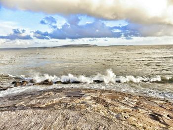 Scenic view of landscape against cloudy sky