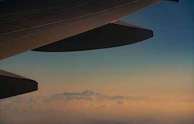 Wing of plane over blurred mountain cover with white snow. airplane flying. airplane window view.