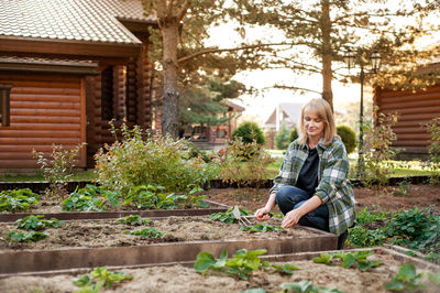 Portrait of smiling young woman sitting outdoors