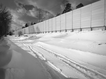 Snow covered field against sky