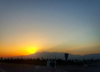 Scenic view of landscape against sky at sunset