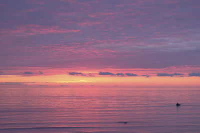 Scenic view of sea against orange sky