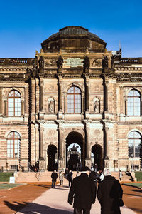 Group of people in front of historical building