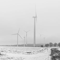 Windmill on field against sky