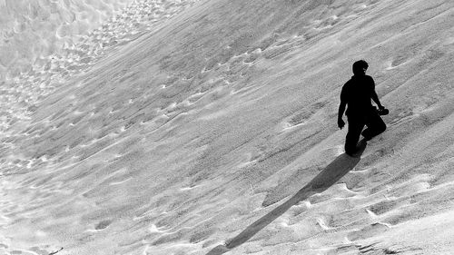 Tilt image of man amidst sand on desert