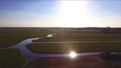 Scenic view of field against sky during sunset