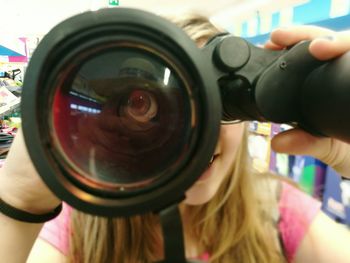 Cropped image of woman holding camera