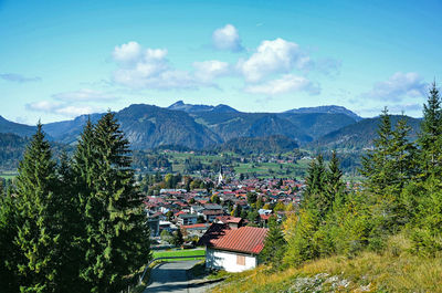 Scenic view of trees and mountains against sky