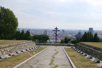 Panoramic view of park by city against sky