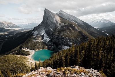 Scenic view of lake by mountains during winter