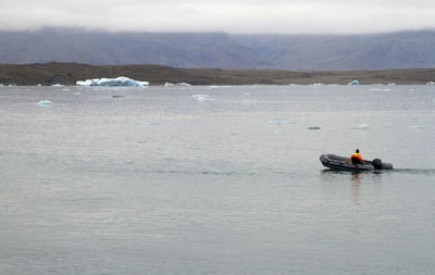 Boat going through a lagoon in iceland with a retreating glacier