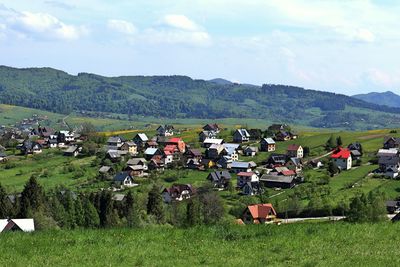 Houses on field against sky