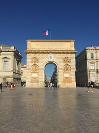 People walking in front of historical building