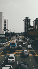 Traffic on road in city against sky