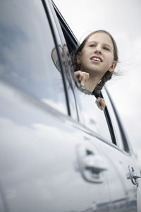 Girl looking through car window