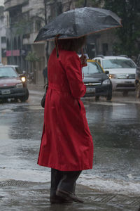 Rear view of people walking on road