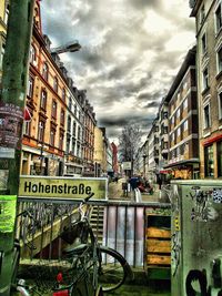 Buildings in city against cloudy sky