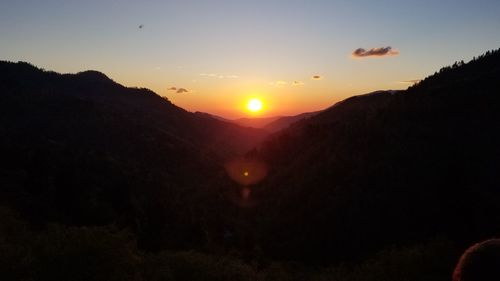 Scenic view of silhouette mountains against sky during sunset