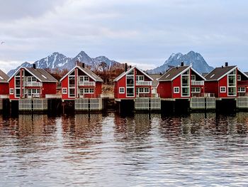 Rorbu cottages in svolvaer, lofoten islands, norway, with background mountain peaks
