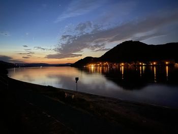 Scenic view of lake against sky at night